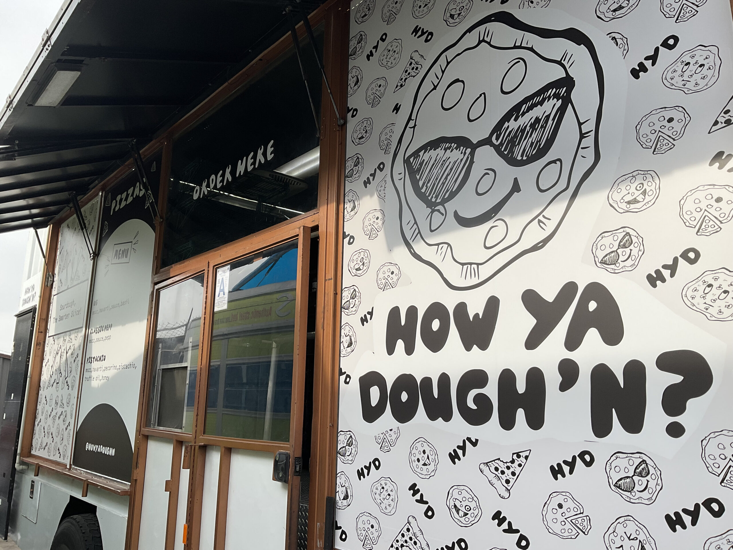 “Custom truck wrap with How Ya Dough’n Pizza branding for Coachella 2026 food truck activation”